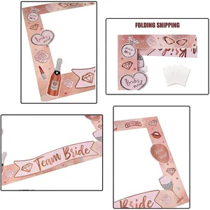Detailed macro view of rose gold bachelorette party paper photo frame and themed props.