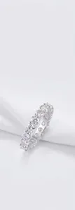 Close-up of a 925 silver moissanite eternity ring with full diamond setting