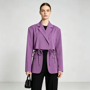 Detail view of purple blazer featuring unique cutout design and waist tie straps