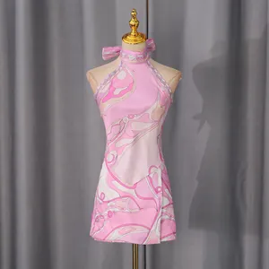 Detail of pink abstract print halter top and mini skirt vacation set on mannequin
