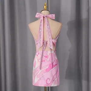 Detailed back view of pink psychedelic print halter tie-up top and matching mini skirt