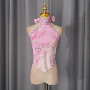 Detailed front view of pink halter top with abstract geometric swirls on a dress form