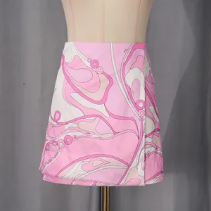 Detail of pink and white abstract swirl print mini skirt on mannequin for resort wear