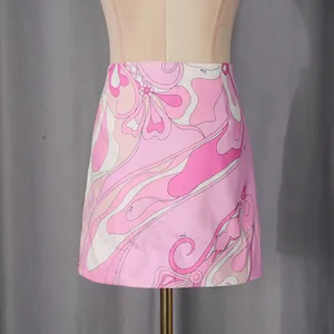 Close-up of pink psychedelic floral print mini skirt on a mannequin for resort fashion