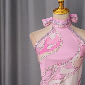 Close-up of pink resort-style halter top with abstract swirl graphic print detail