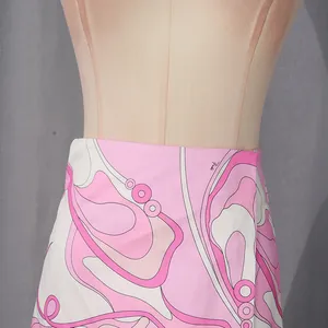 Detail of vibrant pink abstract print on a high-waisted vacation style skirt