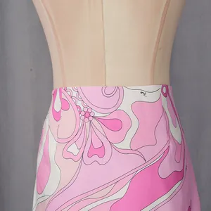 Close-up of vibrant pink floral geometric print on a vacation style high-waist skirt