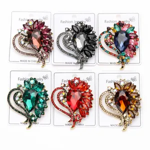 Close-up of heart-shaped glass brooches in various colors for women's fashion.