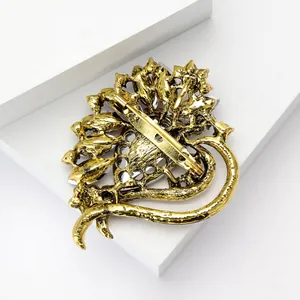 Detail view of the back of a vintage gold heart brooch showing the pin clasp.
