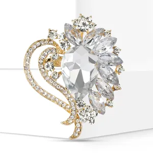 Detailed macro shot of an elegant heart-shaped brooch featuring a large teardrop crystal center