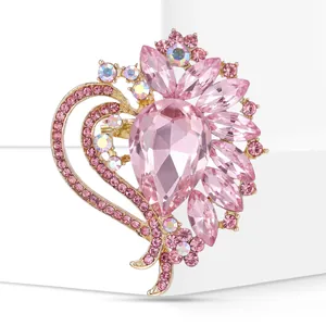 Elegant pink heart-shaped brooch with large teardrop crystal and iridescent rhinestones