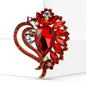 Close-up of red glass heart brooch with intricate geometric crystal details