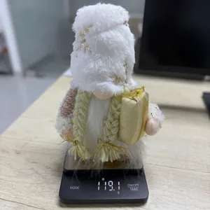 Detailed view of a plush white Christmas gnome on a digital scale weighing 119.1g