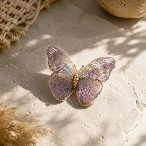 Macro view of a handmade embroidered butterfly brooch with elegant metallic gold finish