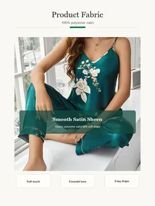 Elegant emerald green satin pajama set with delicate floral print and soft drape