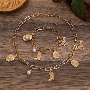 Macro view of vintage Western cowboy style gold necklace and bracelet set with charms.