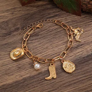 Close-up of Western charm bracelet with vintage cowboy hat and boot pendants on rustic wood