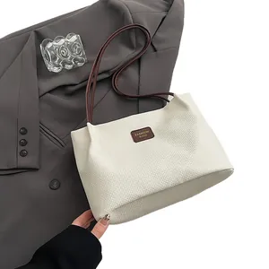 Stylish off-white textured tote bag with brown straps for women's daily commute
