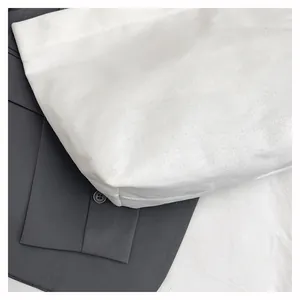 Close-up of white canvas bucket bag showing durable fabric texture and minimalist design