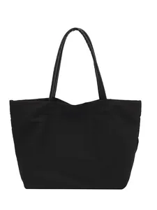 Minimalist black canvas tote bag with large capacity and thin shoulder straps for daily use