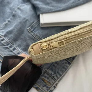 Detailed macro shot showcasing the high-quality golden zipper of this woven straw bag