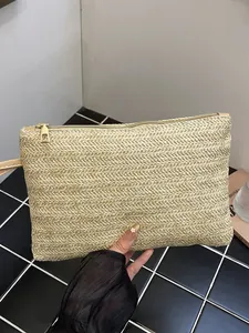 Handmade minimalist straw woven clutch bag for beach holidays and seaside vacation use