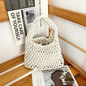 Detail view of handmade woven cotton rope hollow bucket bag for beach vacation