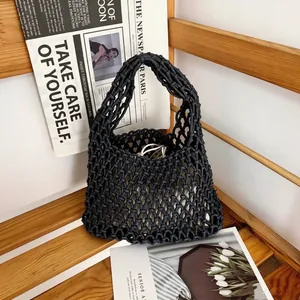 Detailed view of a black hand-woven mesh bag featuring hollow cotton rope design
