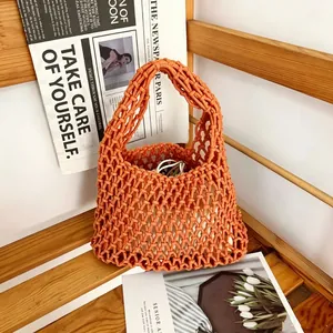 Detailed view of the orange handmade woven cotton rope mesh bag with open-work texture