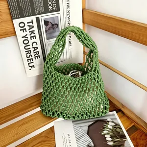 Detailed view of a green hand-woven cotton rope mesh bag perfect for beach vacation style