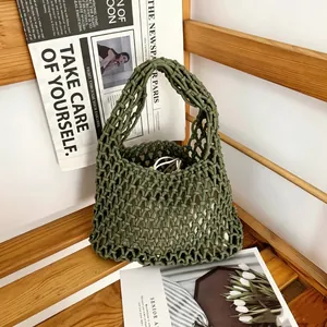 Detailed close-up of a handmade woven cotton rope mesh bag ideal for beach vacation styling