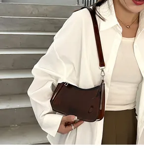 Close-up shot of a stylish brown transparent jelly hobo bag worn as an armpit bag