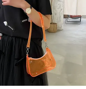 Stylish transparent orange jelly shoulder bag for women worn as a trendy underarm bag