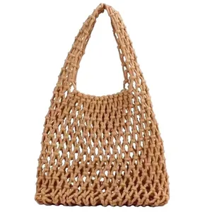 Handmade woven cotton rope mesh handbag for beach vacation and casual summer style.