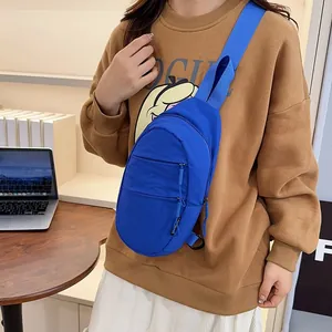 Casual blue nylon chest bag for unisex outdoor travel shown in a stylish lifestyle setting