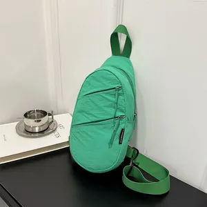 Close-up of a mint green nylon casual chest bag against a clean minimalist background