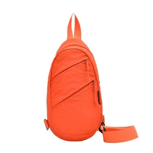 Vibrant orange nylon sports sling bag with adjustable strap and front zipper pockets