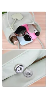 Detail view of the light green tote bag's internal capacity and magnetic closure