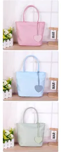 Collection of pastel nylon tote bags in pink blue and green with cute heart charms