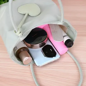 Mint green dopamine style tote bag showing interior storage capacity with heart charm