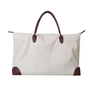 Large capacity travel tote bag for women with brown leather handles and off-white nylon body