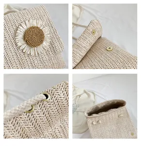 Detalles de un bolso de paja tejida con una flor de margarita blanca y herrajes dorados