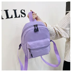 Detailed view of small purple nylon backpack with front pocket and adjustable straps