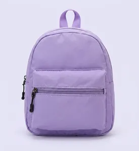 Close-up view of a purple nylon backpack showing durable fabric and front zipper pocket