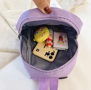 Interior capacity of purple nylon backpack showing organized personal items