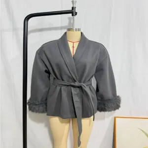 Elegant grey wool coat featuring faux fur trim cuffs and an adjustable waist tie belt