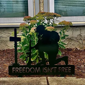 Black metal kneeling soldier memorial garden stake with Freedom Isn't Free text decoration