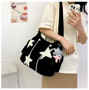 Black corduroy tote bag with white star patches and cute plush star keychain accessory