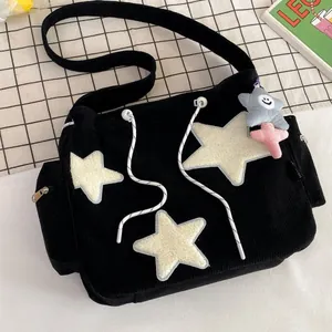 Cute black corduroy tote bag with large plush star patches and drawstrings for school
