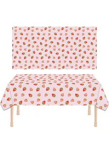 Close-up showing the detailed strawberry print pattern on a pink disposable party tablecloth